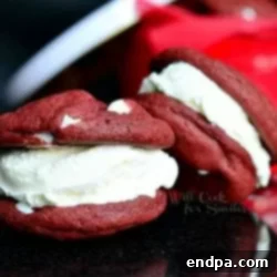 29 Irresistible Red Velvet Desserts 6 Red Velvet Ice Cream Sandwich Cookies filled with creamy cheesecake ice cream and festive M&M candy, a perfect frozen treat.