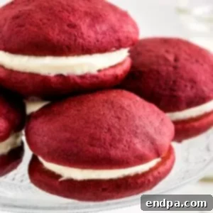 29 Irresistible Red Velvet Desserts 8 Soft red velvet whoopie pies, two small cakes filled with a dreamy cream cheese filling, displayed on a serving plate.