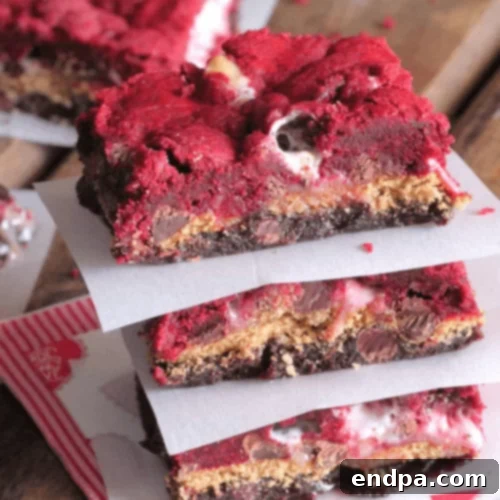 29 Irresistible Red Velvet Desserts 9 Vibrant Red Velvet S’mores Bars, showcasing layers of cake mix, brownie, gooey marshmallows, and chocolate.