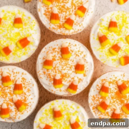 Cups with candy corn on top.