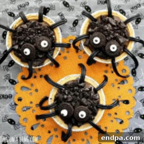 Spider pudding pies on an orange place mat.