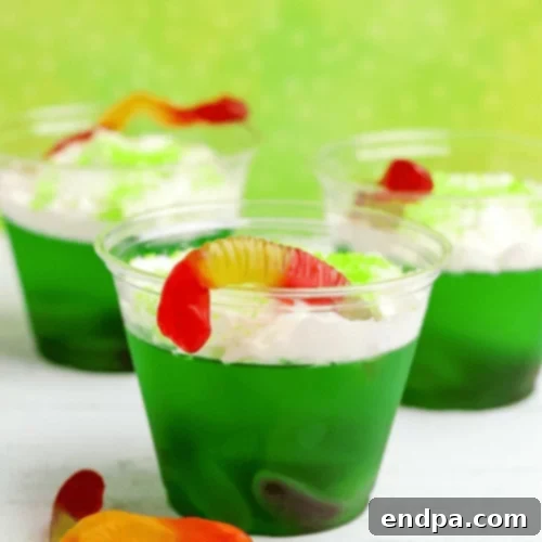 Halloween jello cups topped with gummy worms.