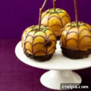Caramel apples on a white pedestal.