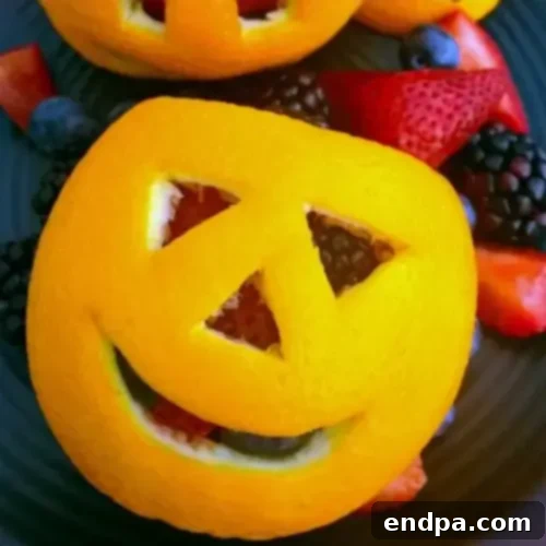 Oranges with faces carved into them.