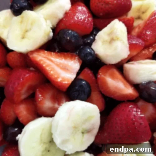 44 Refreshing No-Bake Summer Treats 11 Colorful Berries and Banana Fruit Salad, featuring a medley of fresh strawberries, blueberries, and sliced bananas.