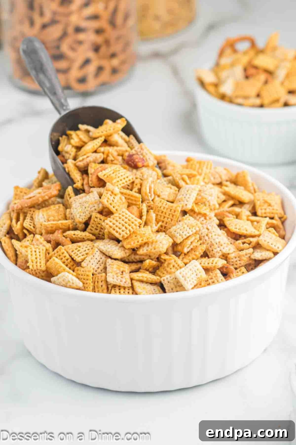 Bowl of Chex Mix with a Scoop, showcasing the delicious blend of sweet and salty flavors