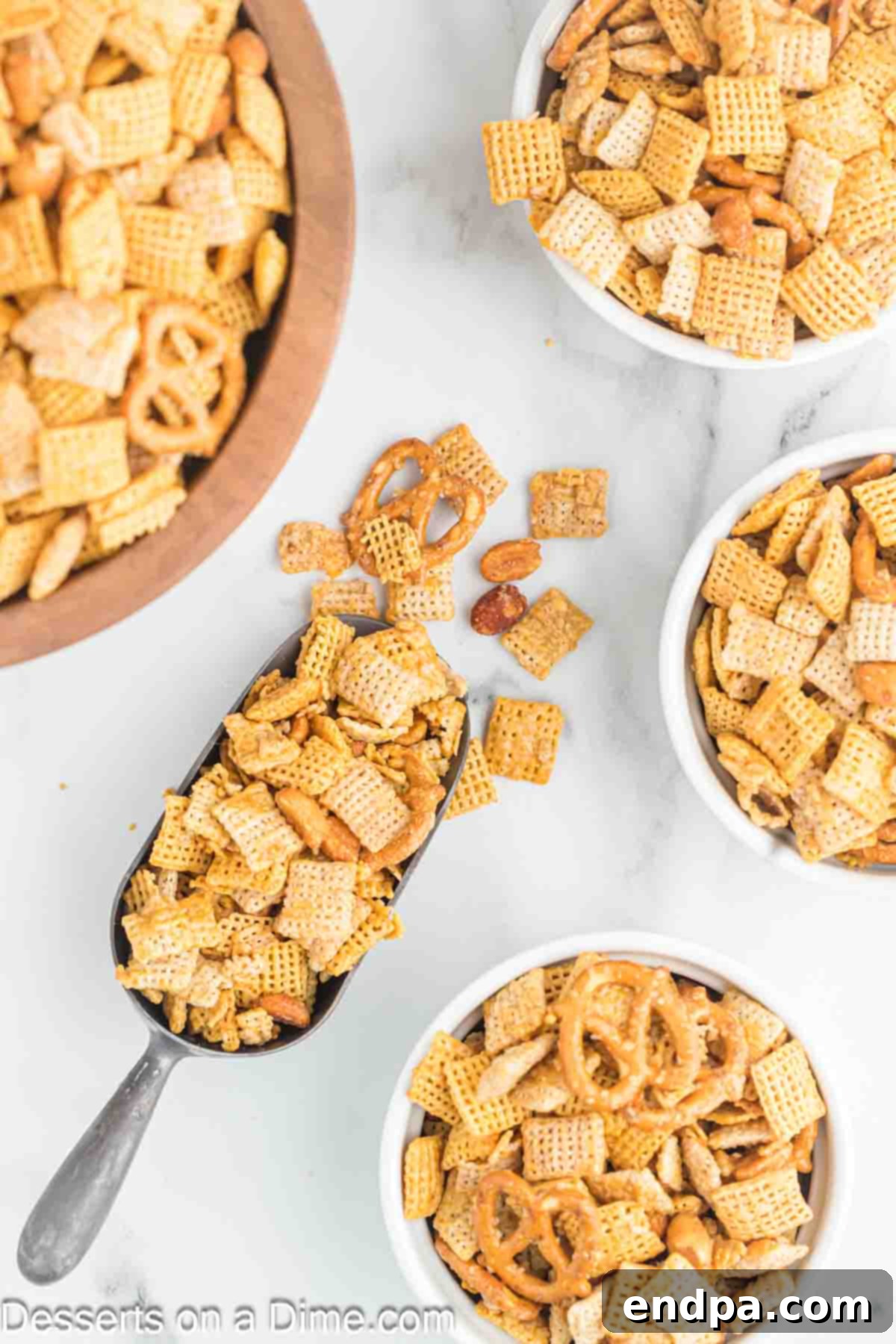 Sweet Chex Mix in a bowl and some in a scoop, ready to be enjoyed as a perfect snack