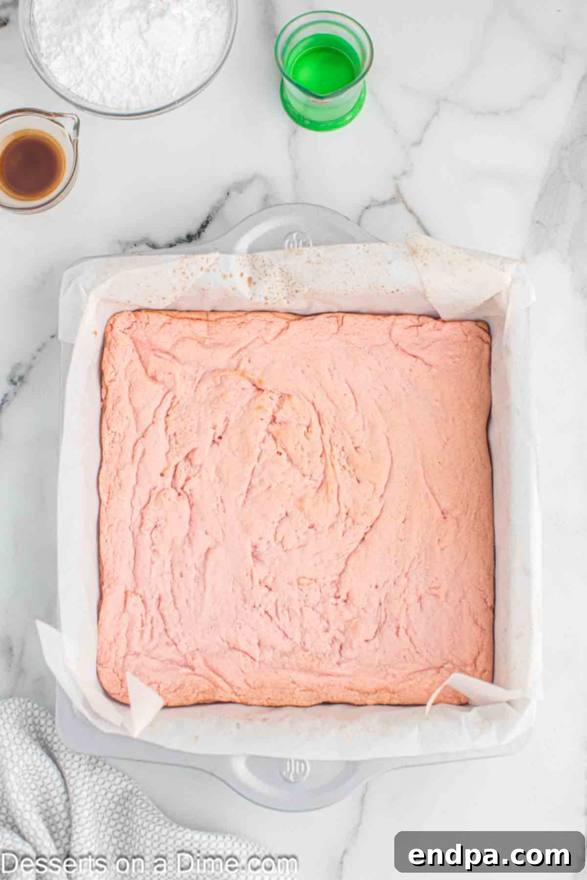 Baked strawberry brownies cooling in the pan after being removed from the oven.