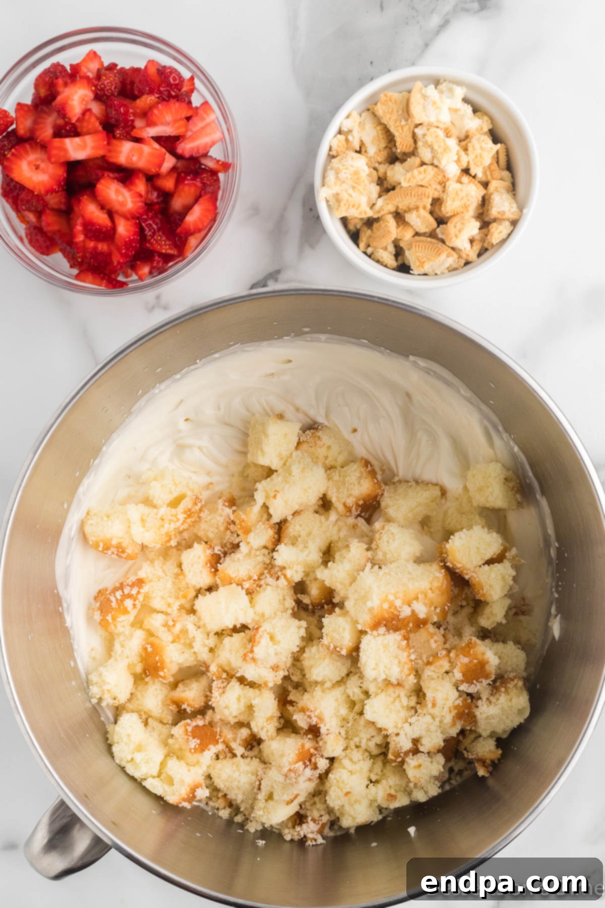 Chopped strawberries and pound cake added to ice cream mixture.