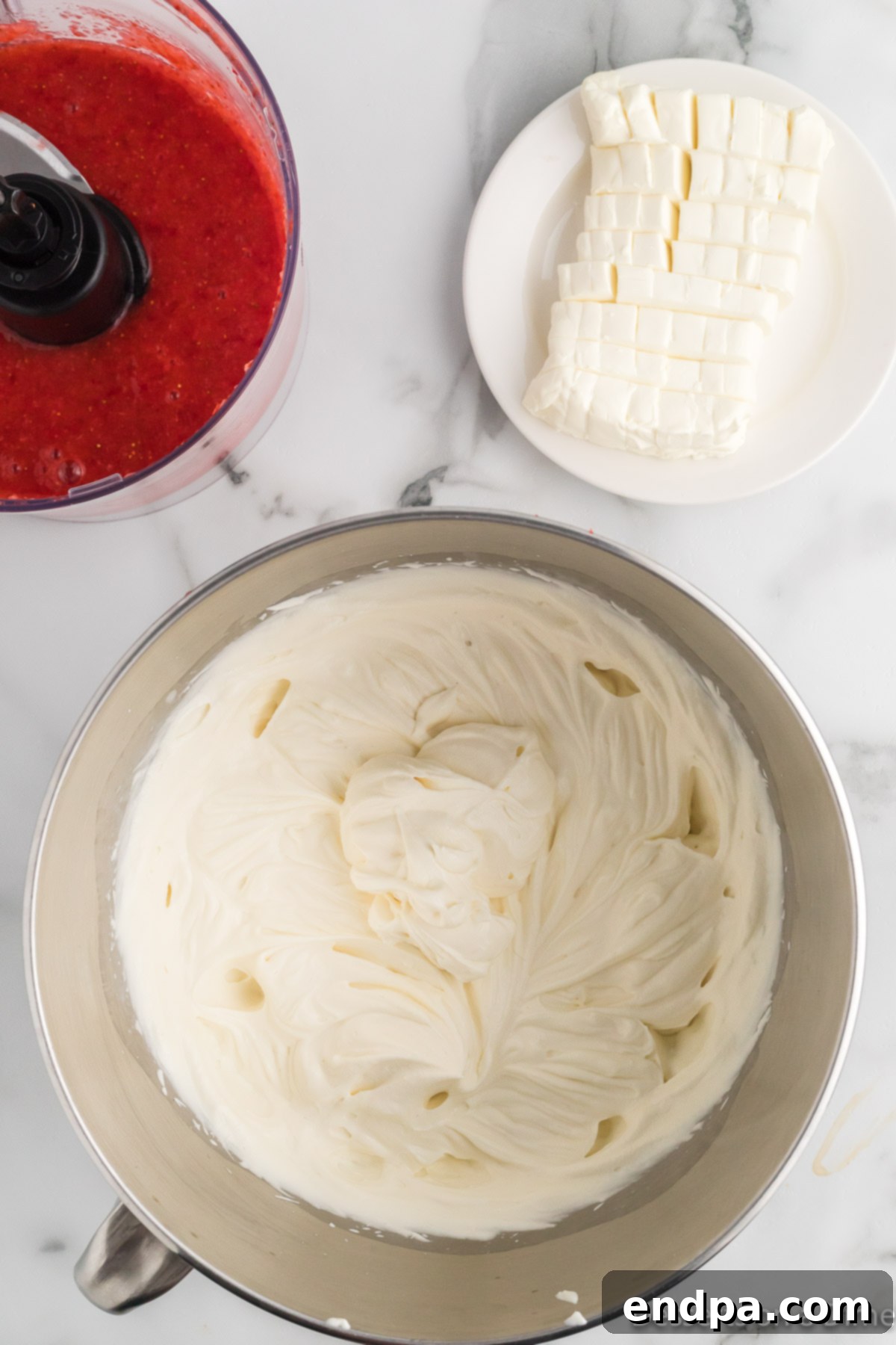 Heavy cream, sweetened condensed milk, and vanilla extract being whisked in a large mixing bowl until stiff peaks form.