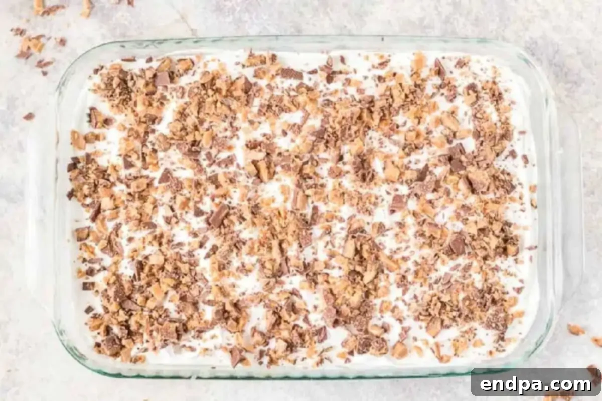 Heavenly Decadence Cake 4 Whipped cream and heath candy spread on cake.