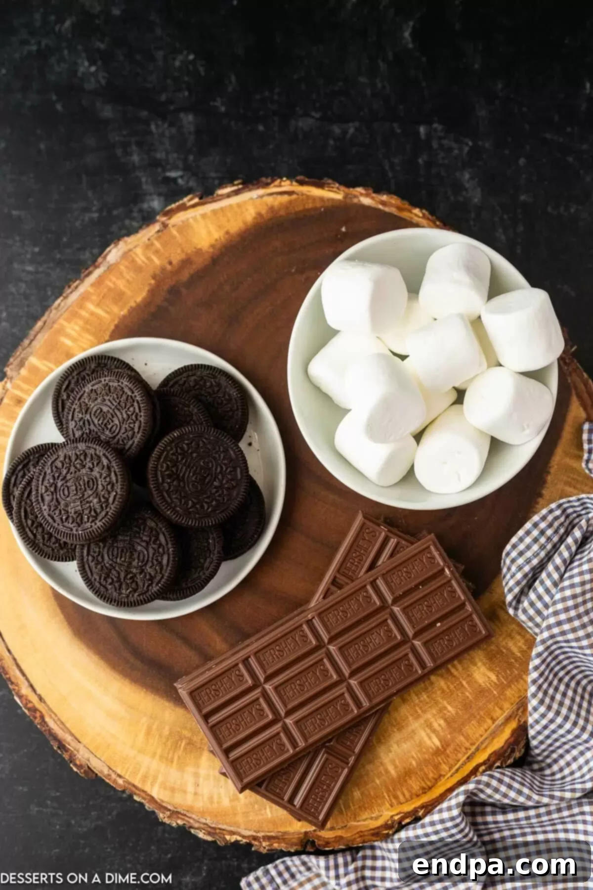 Oreo S'mores Dream 3 Ingredients for Oreo s'mores laid out: marshmallows, whole Oreo cookies, and chocolate bar pieces.