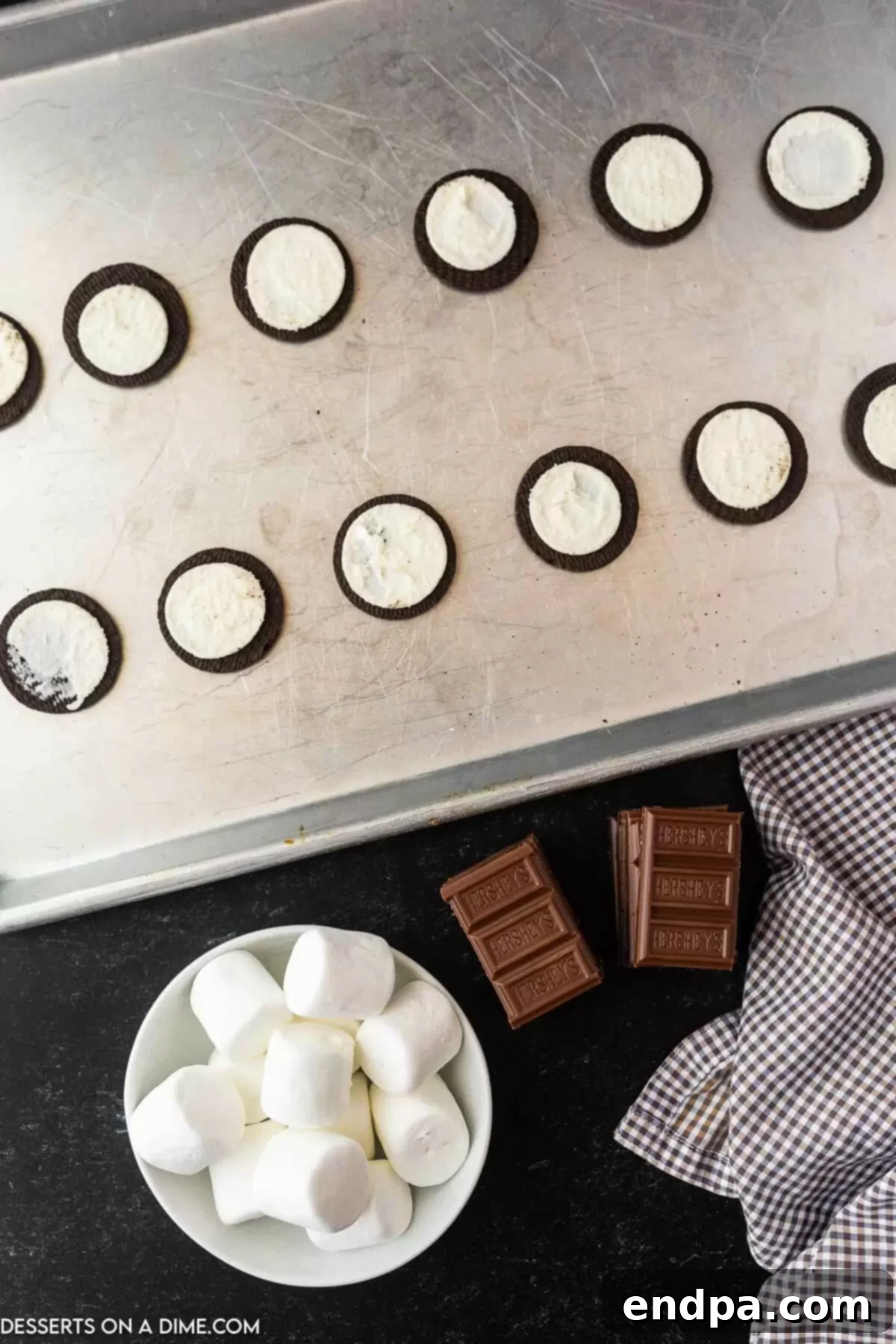 Oreo S'mores Dream 4 Oreo cookies separated and placed cream-side up on a baking sheet lined with parchment paper.