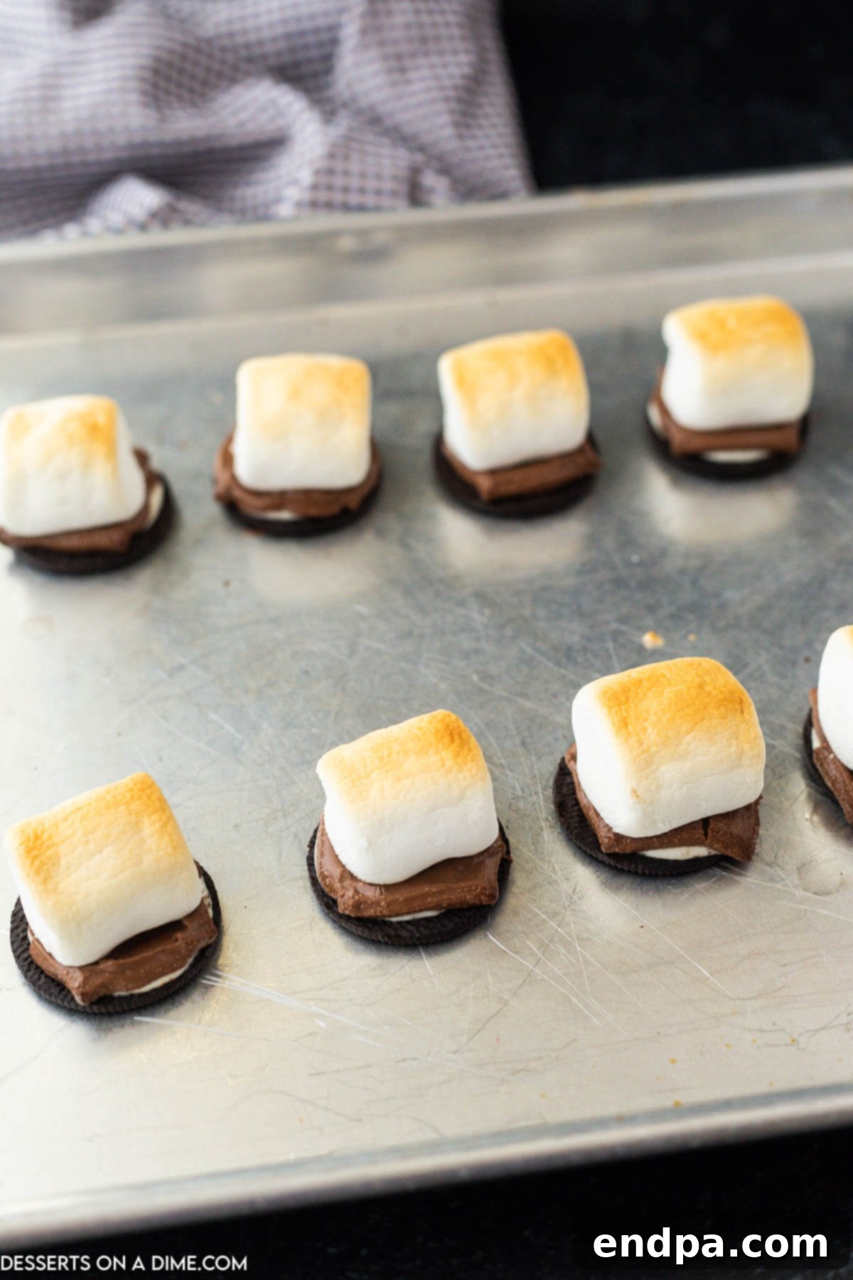Oreo S'mores Dream 6 Marshmallows turning golden brown and puffy under the oven broiler on the baking sheet.