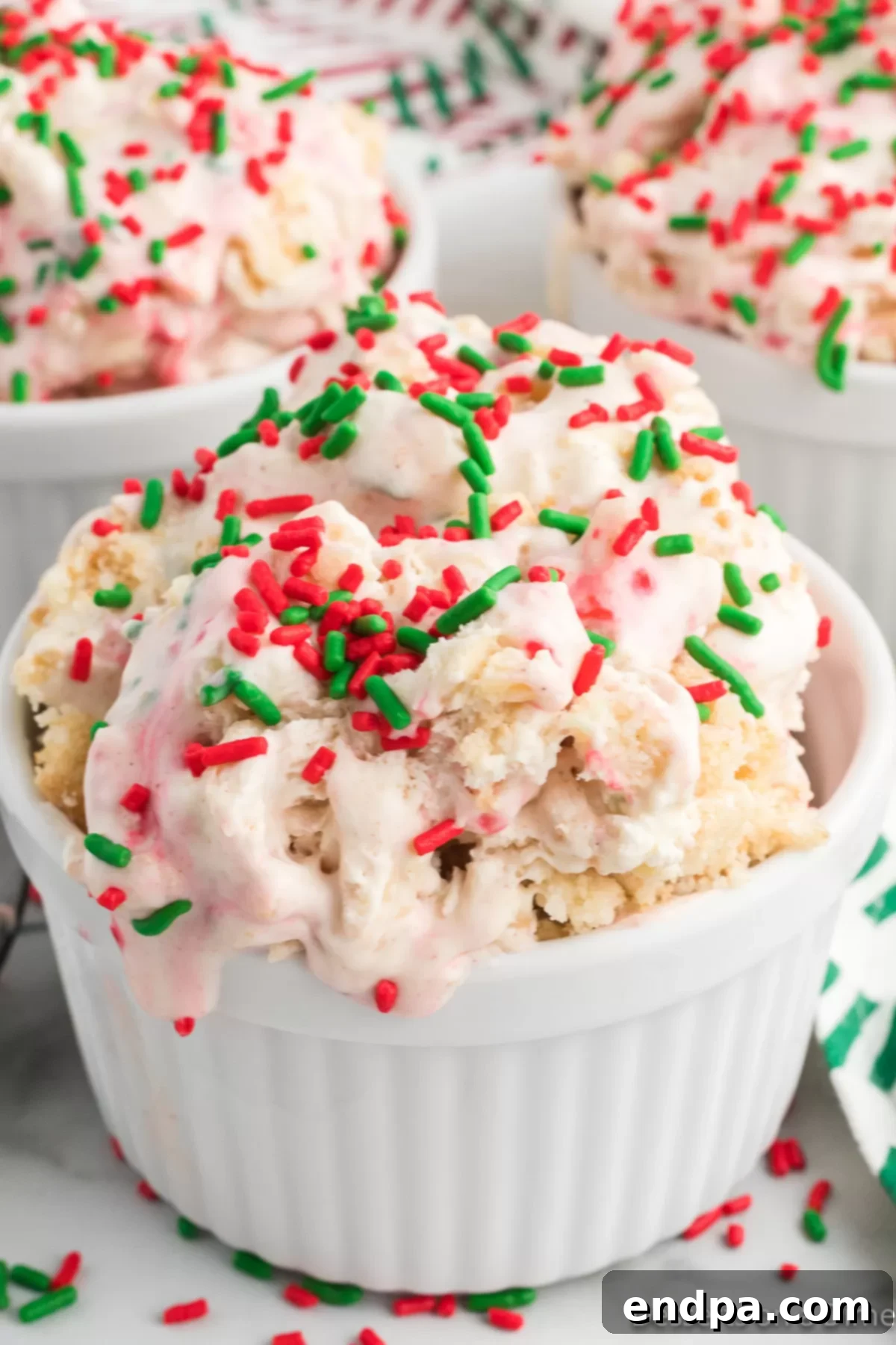 Merry Melts 2 A beautifully scooped bowl of homemade Christmas Ice Cream, garnished with festive sprinkles, ready to be enjoyed.