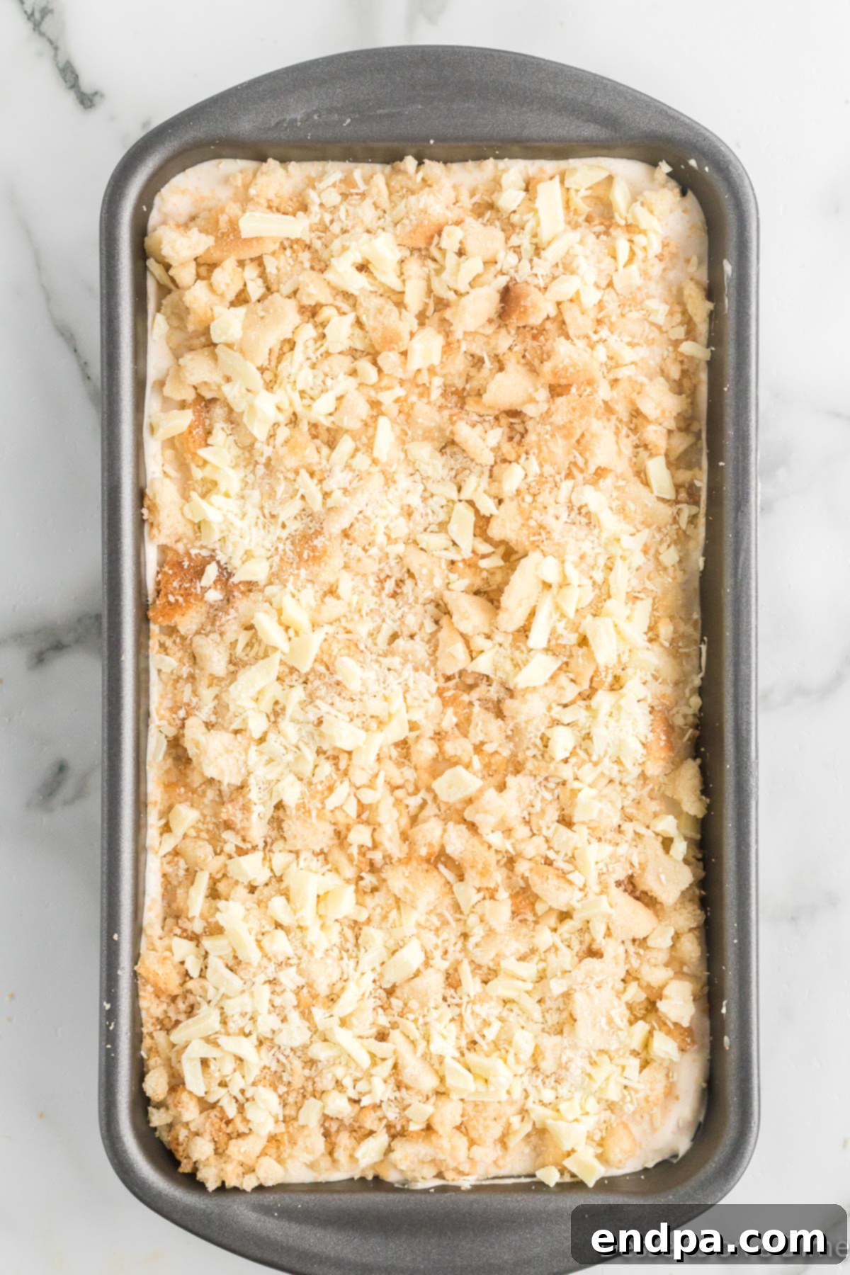 Merry Melts 12 The loaf pan filled with layered Christmas ice cream mixture, topped with reserved cookies and white chocolate.