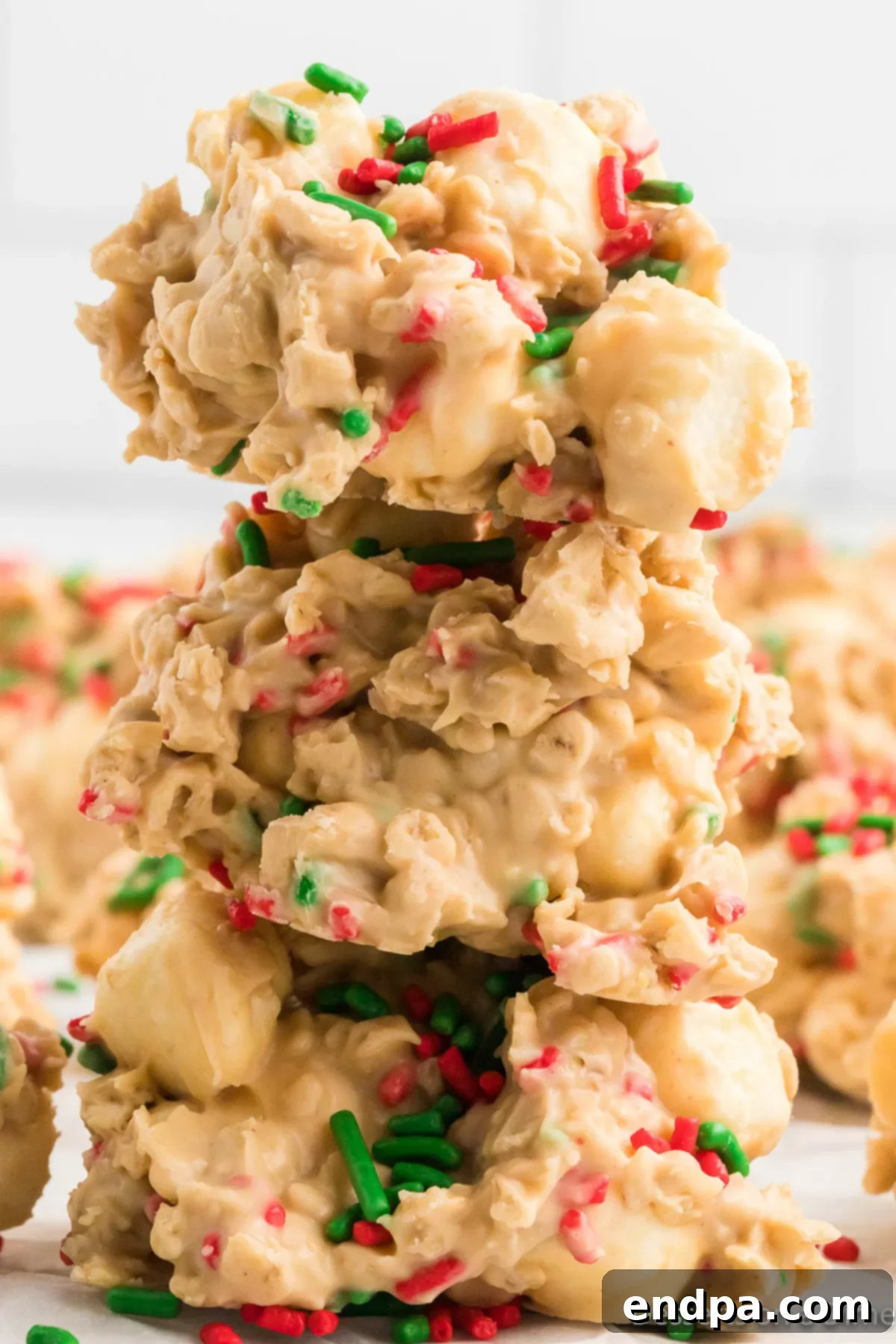 Festive No-Bake Delights 2 Christmas No Bake Cookies stacked together, adorned with red and green sprinkles, ready for holiday celebrations.