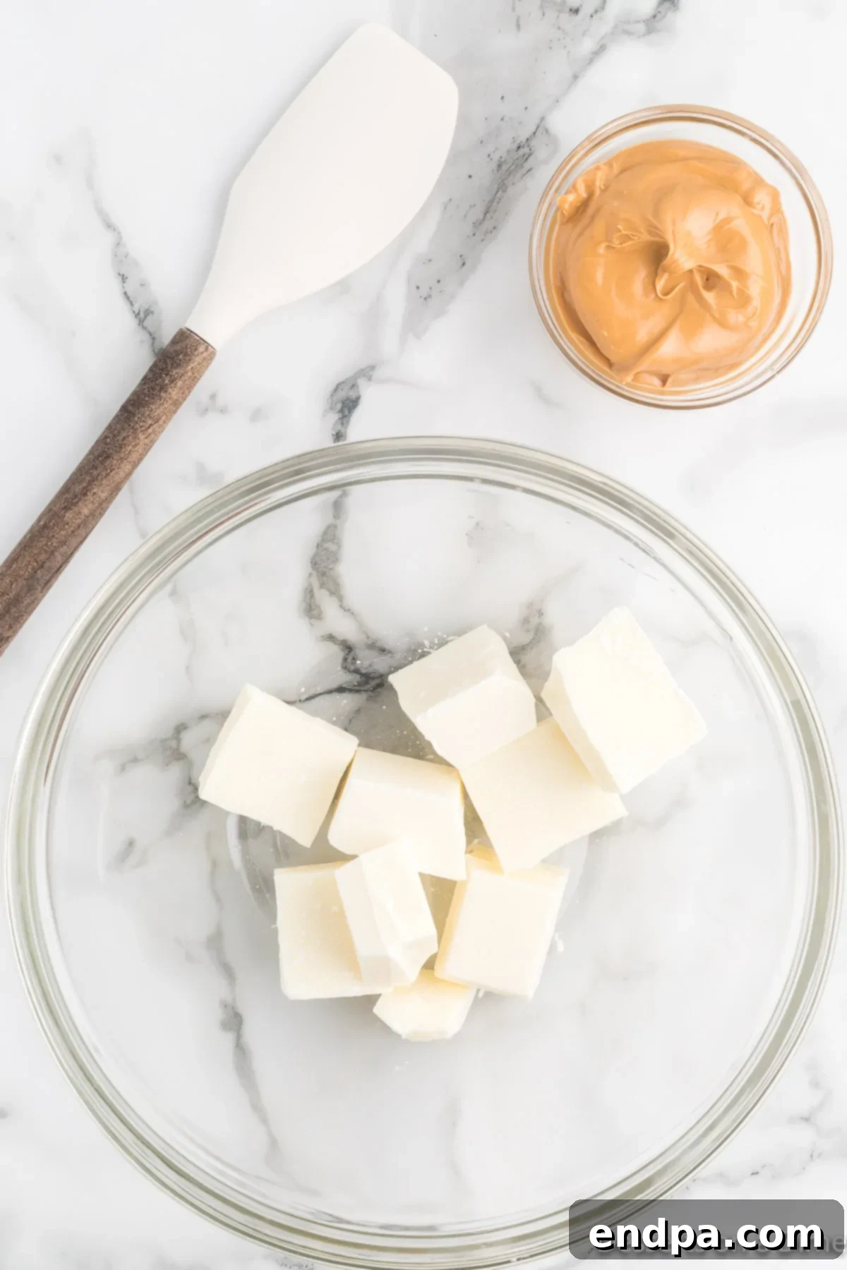Festive No-Bake Delights 4 White chocolate bark broken into pieces in a large mixing bowl, ready for melting.
