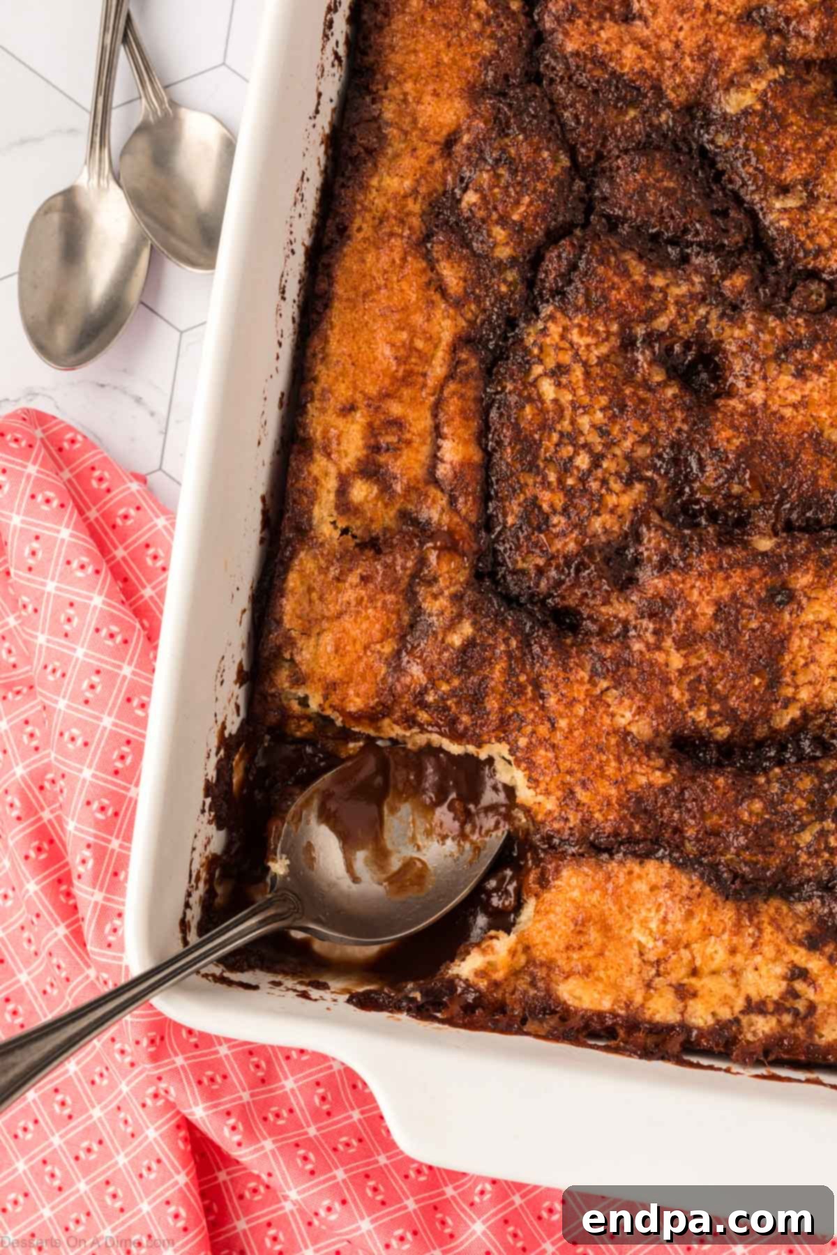 Chocolate Cobbler in the baking dish with a spoon