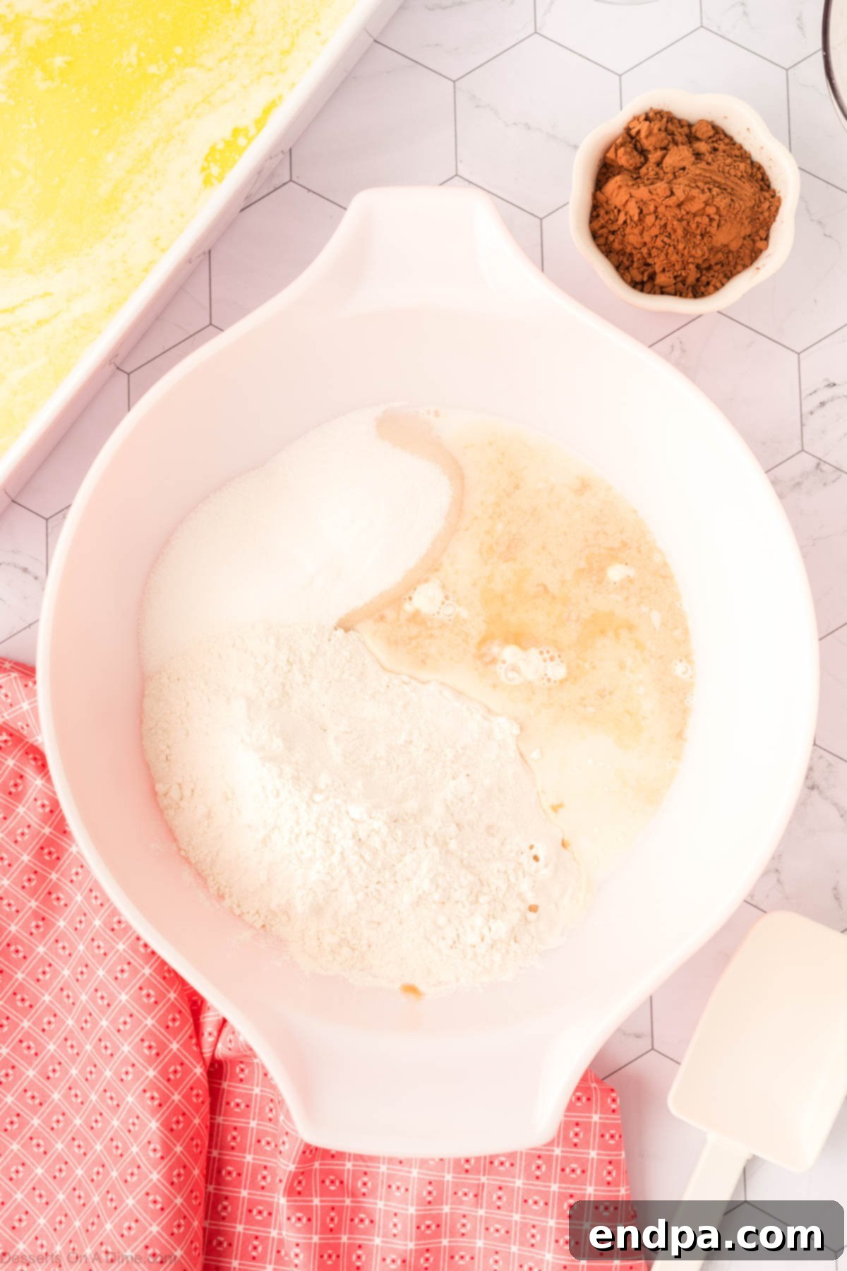 Combining the flour, baking powder, salt, sugar, milk, vanilla together