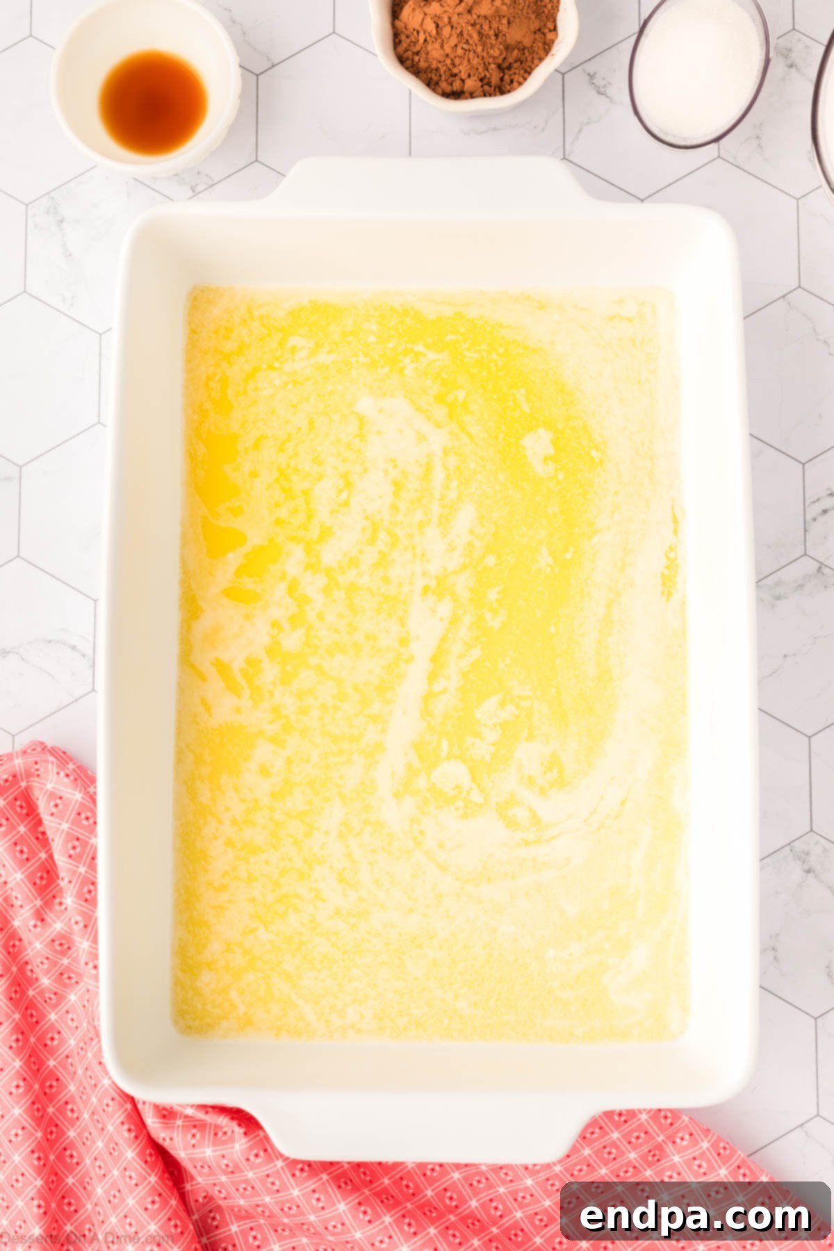 Pouring the flour mixture into the baking dish with the melted butter