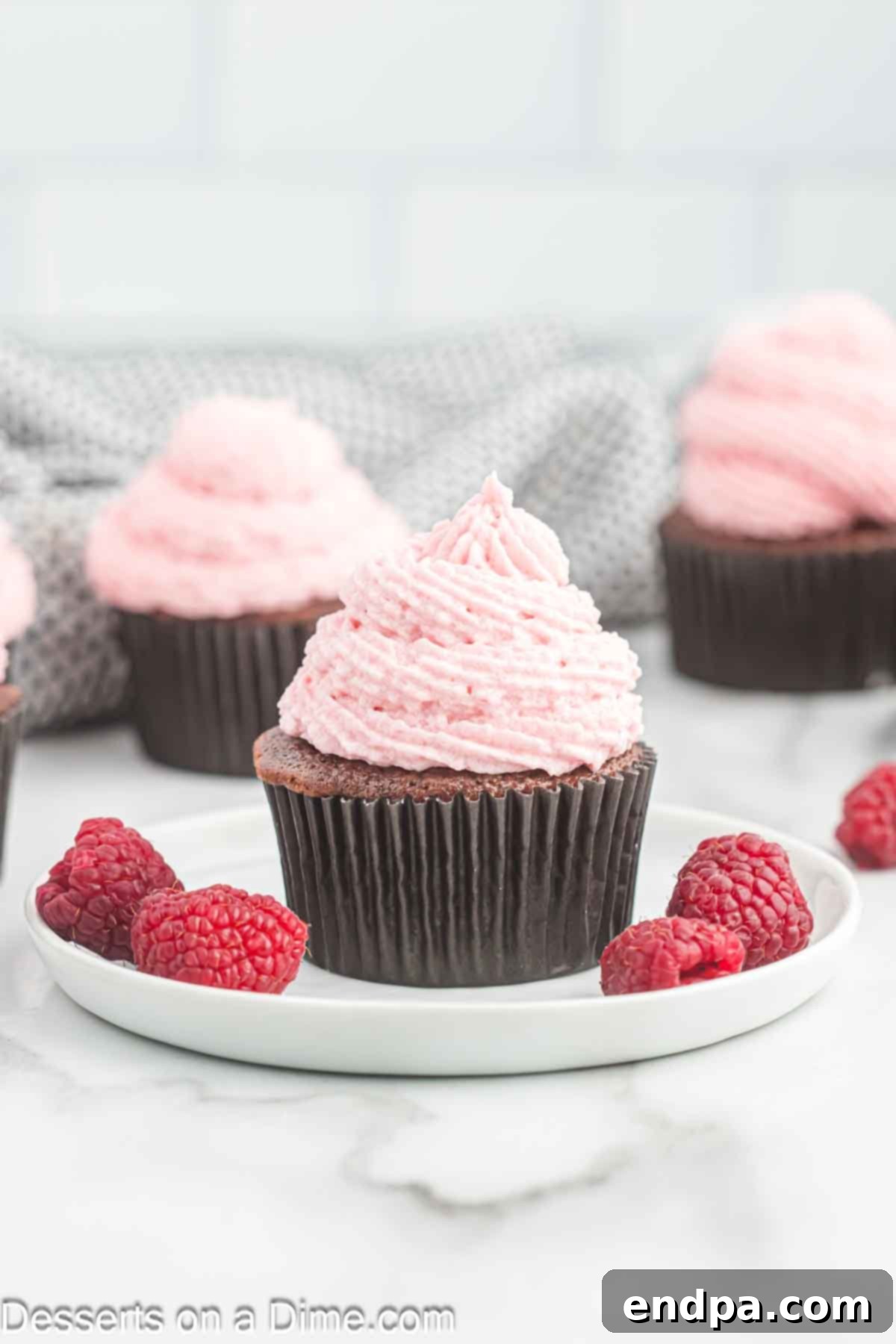 Raspberry frosting on cupcakes, showcasing its beautiful natural pink hue.