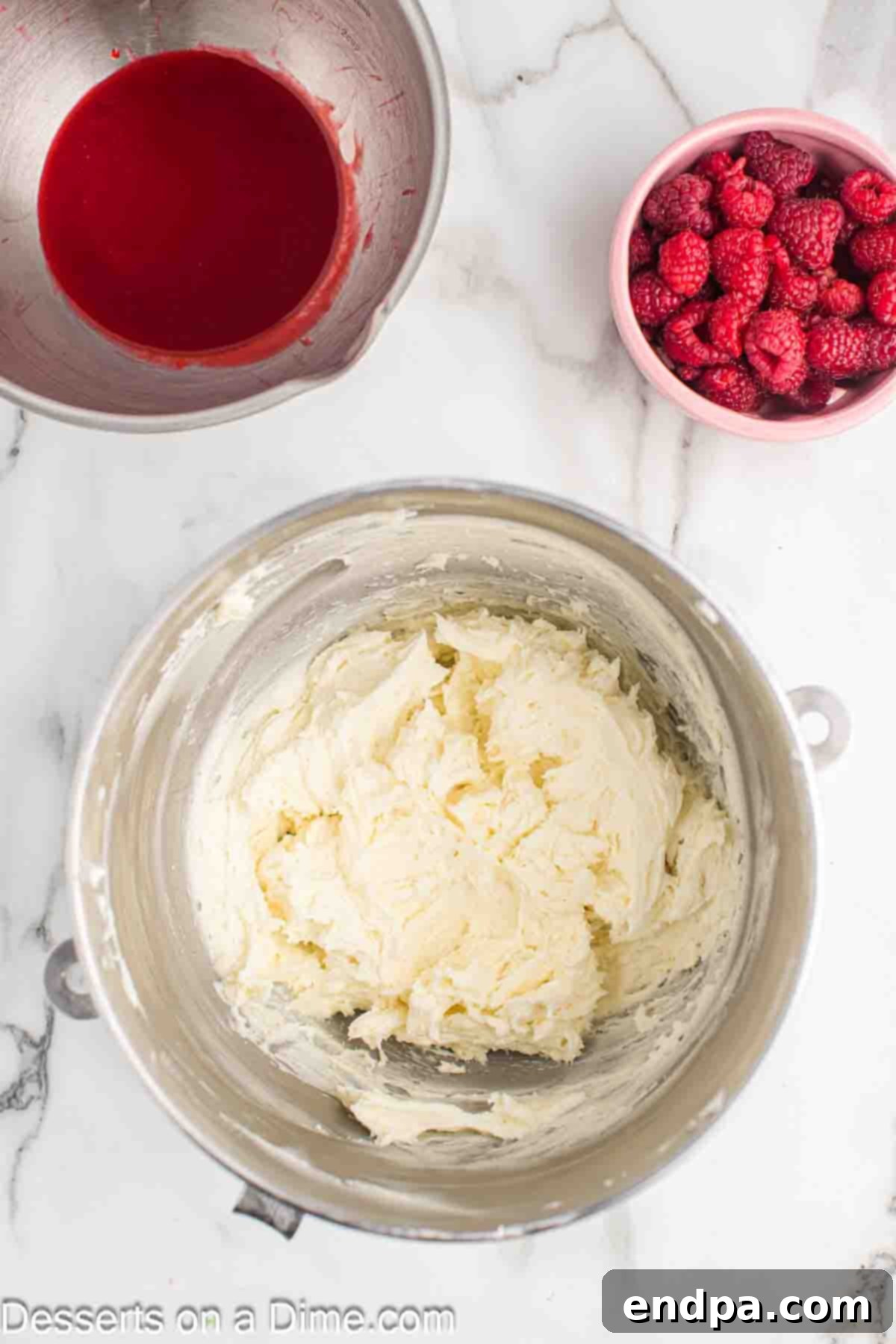 Softened unsalted butter and sifted powdered sugar being creamed together in a large mixing bowl with an electric mixer.