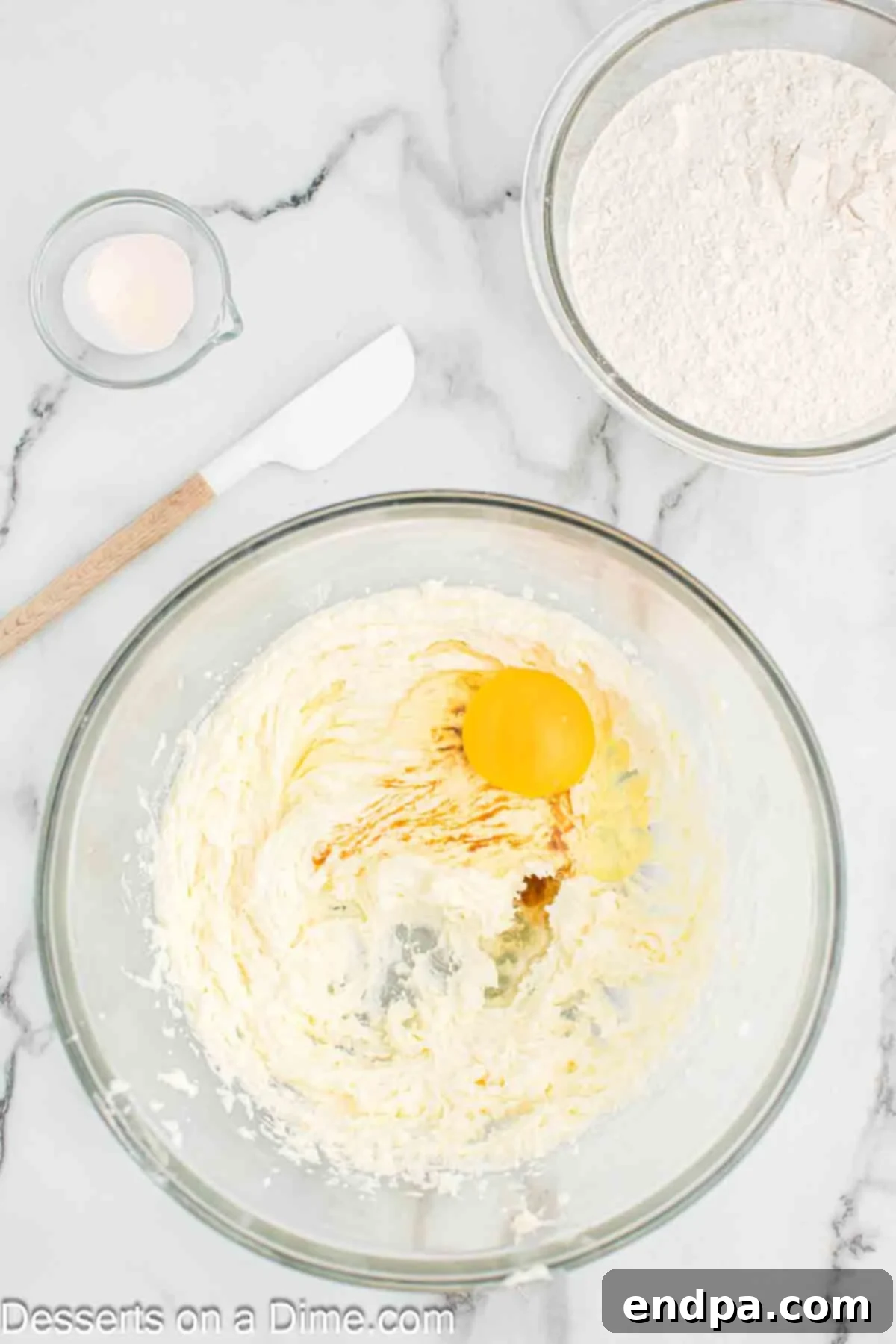 Rainbow Unicorn Drops 5 Mixing bowl with egg and vanilla extract added to the creamed mixture.