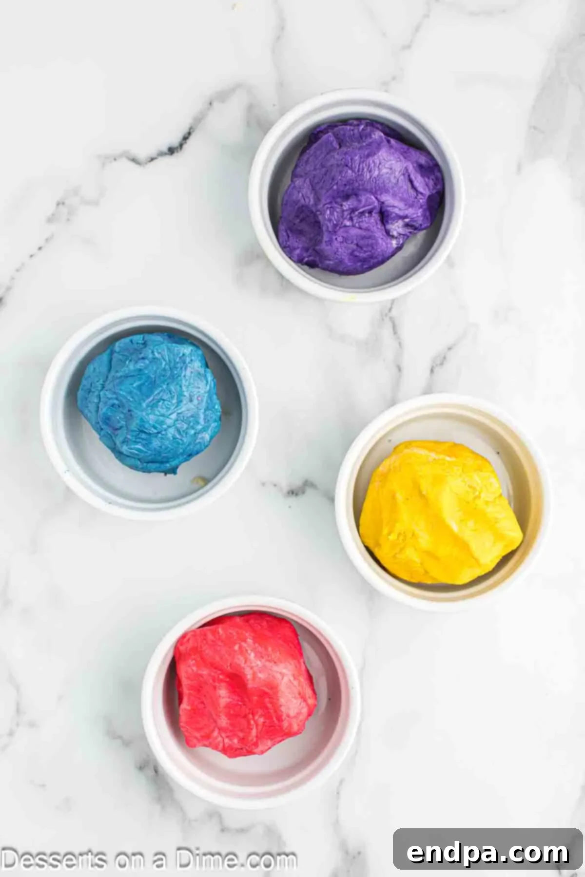 Rainbow Unicorn Drops 8 Four separate bowls of cookie dough, each dyed a different vibrant color and ready for chilling.