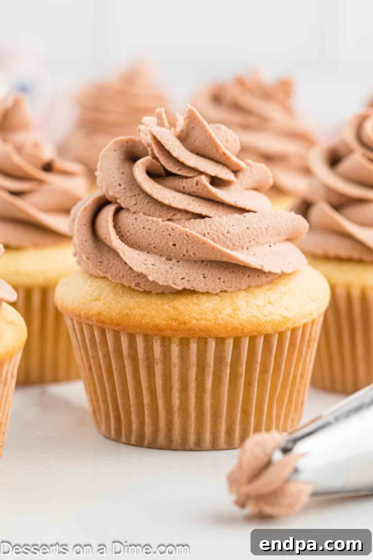 Whipped Nutella Delight 2 Nutella frosting on cupcakes, beautifully piped and ready to enjoy.