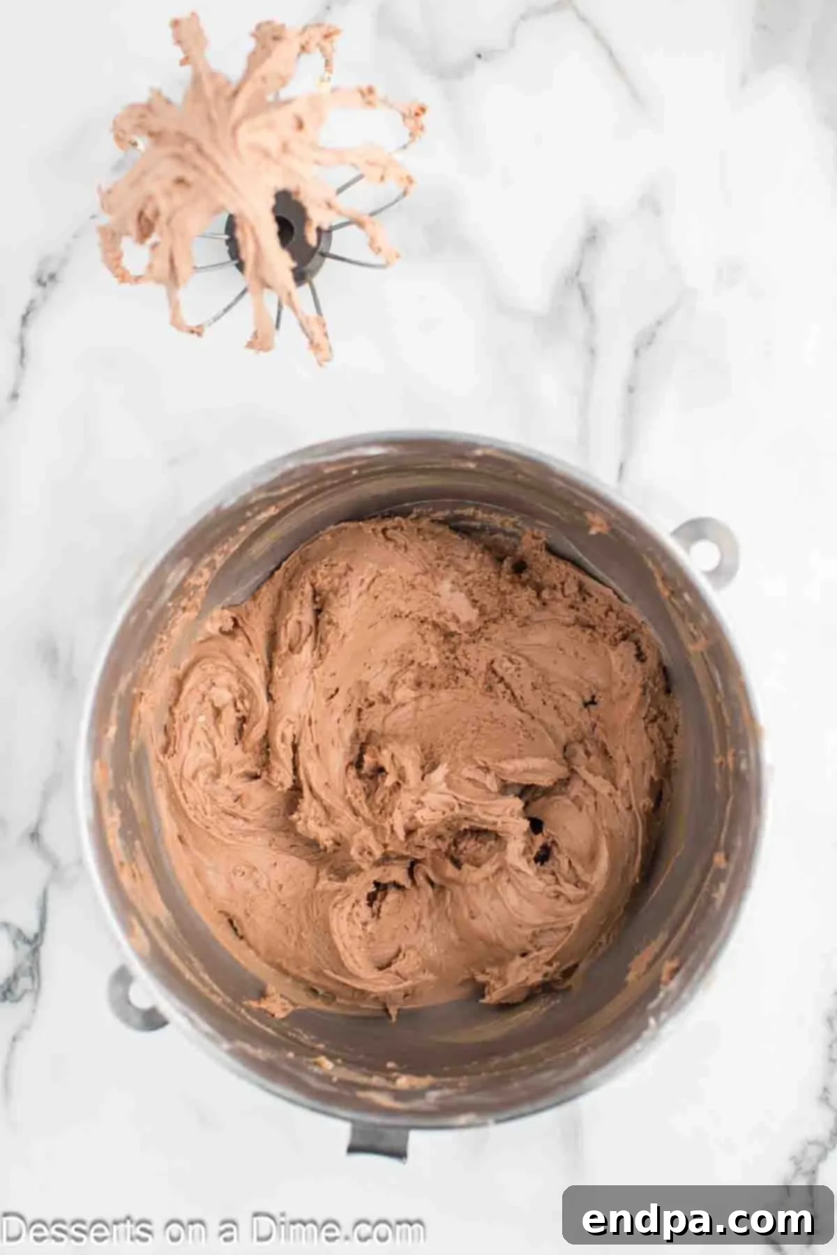 Whipped Nutella Delight 6 Powdered sugar being gradually added to the mixing bowl and combined with the Nutella frosting.