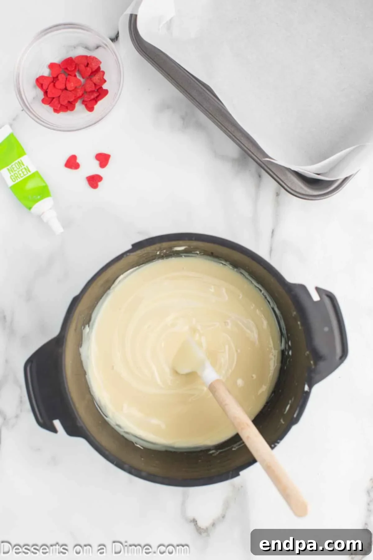 Melting White Chocolate and stirring with a spatula in a microwave-safe bowl.