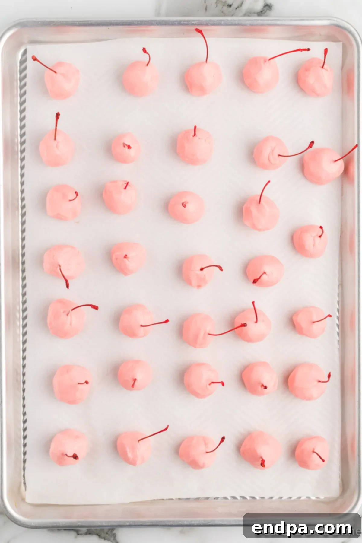 Cherries placed on baking sheet. 