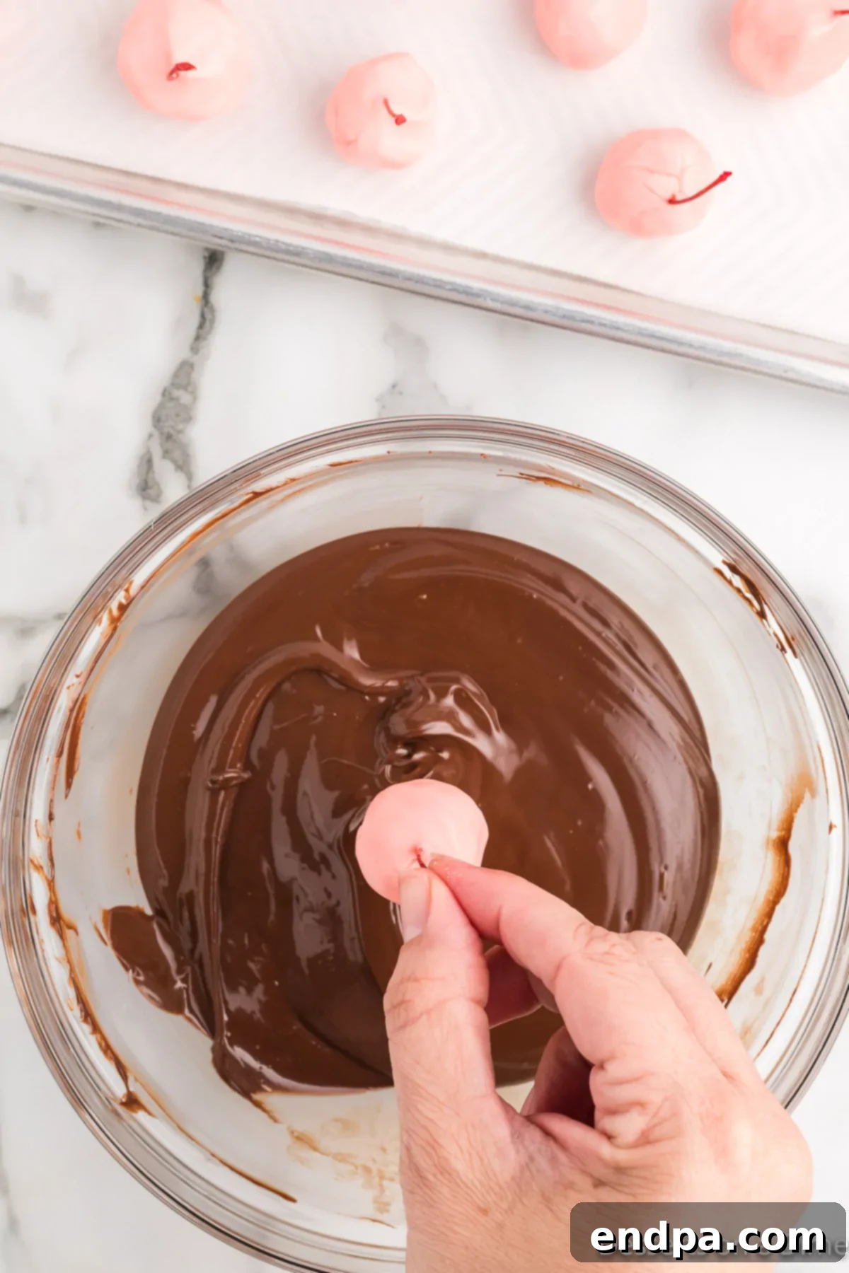 Cherries dipped in melted chocolate. 