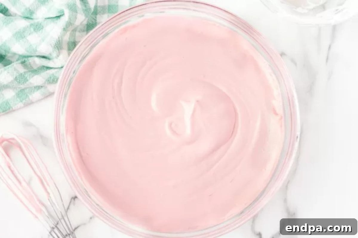 Strawberry Jello pie filling in a clear bowl, showing its light and airy texture