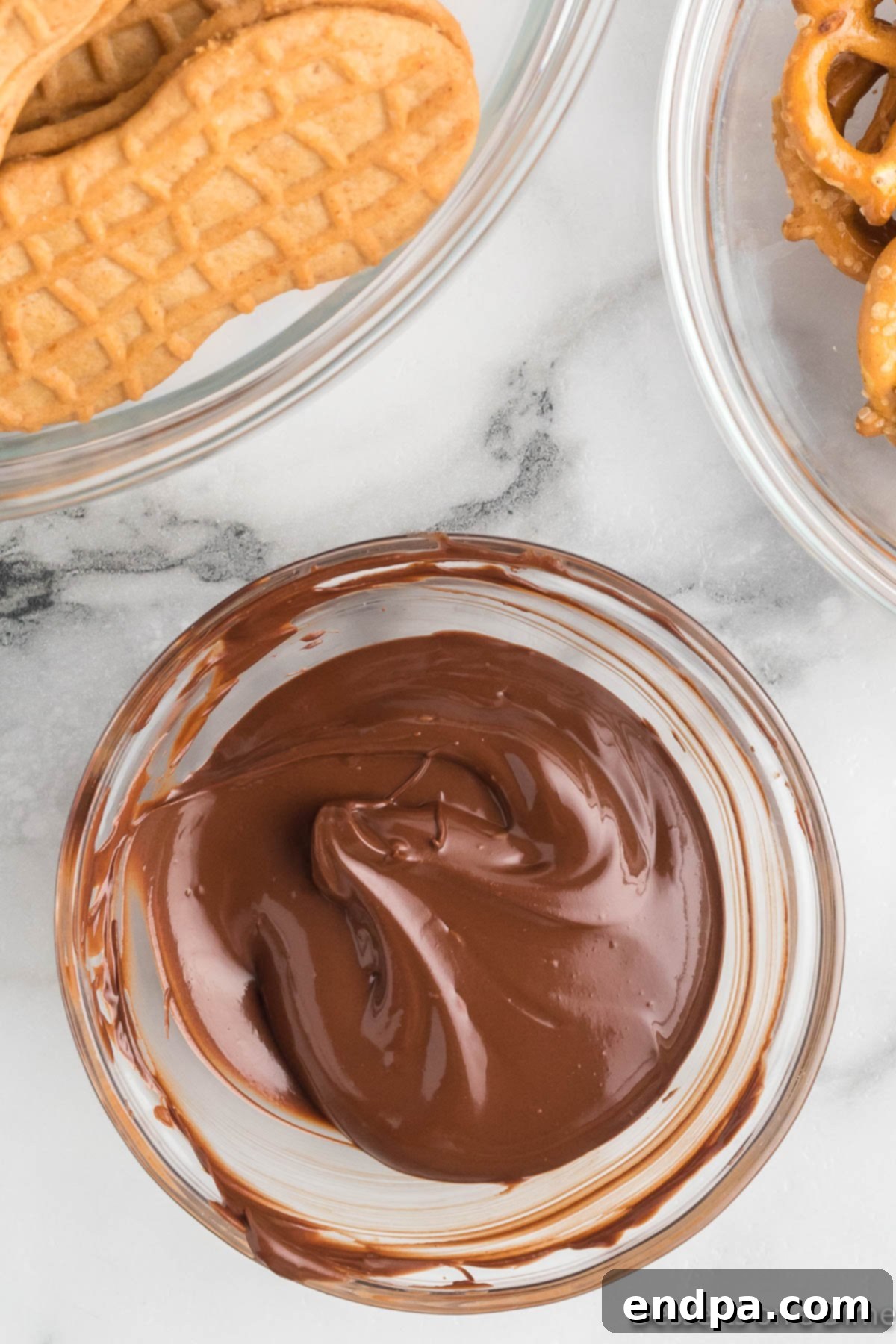Chocolate chips melting in a microwave-safe bowl, being stirred to ensure even melting.