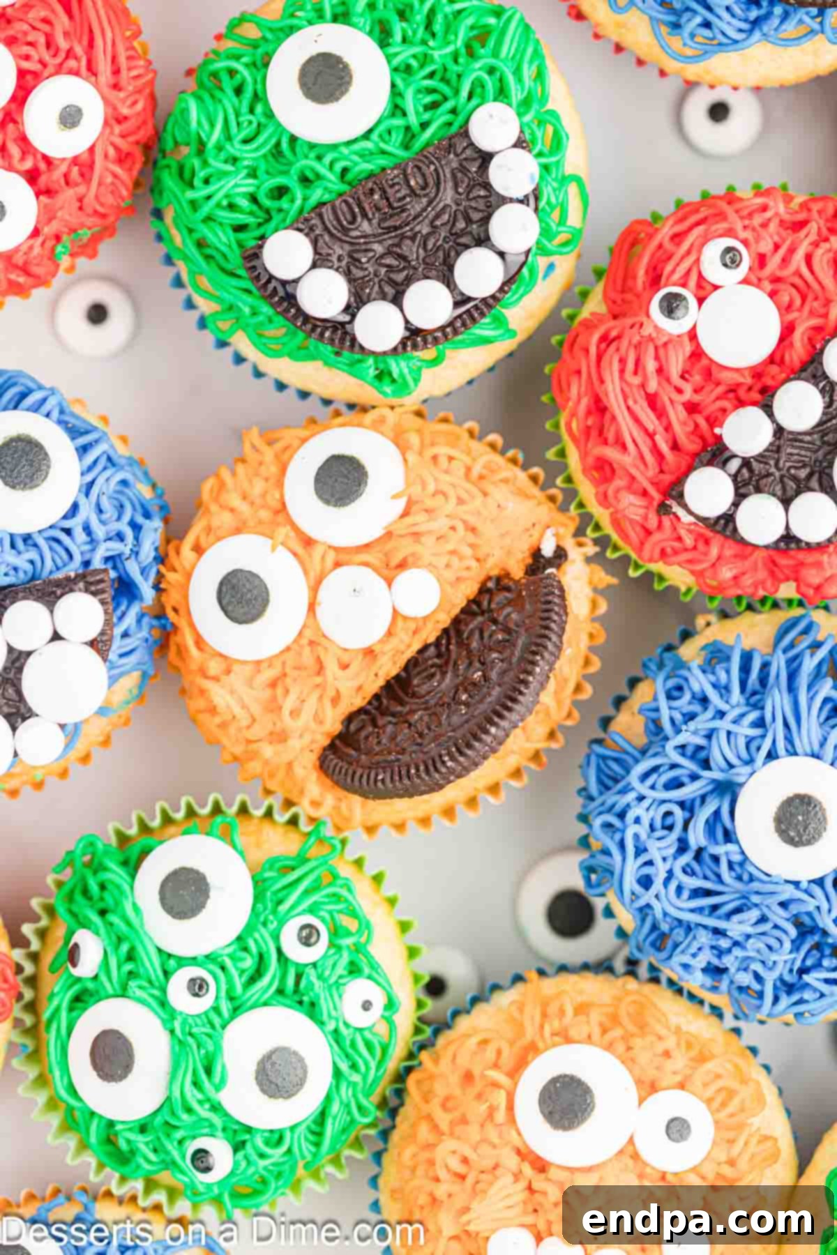 Spooktacular Monster Cupcakes 2 Vibrant Monster Cupcakes with colorful frosting and candy eyes arranged on a counter.