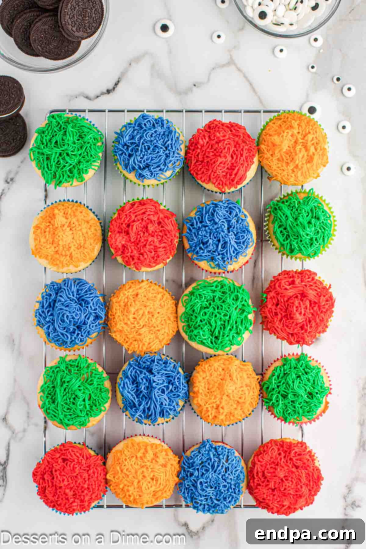 Spooktacular Monster Cupcakes 9 Cupcakes on wire rack decorated with frosting.