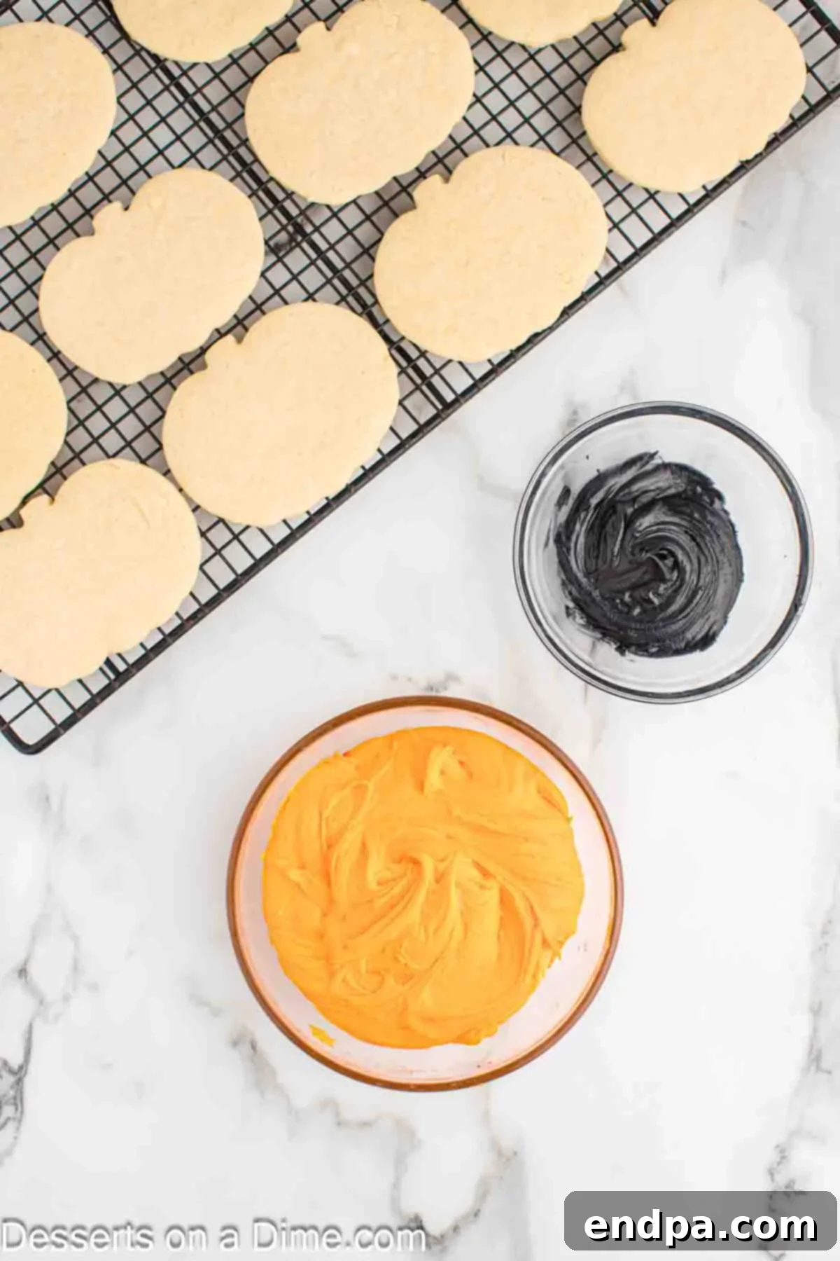 Frightfully Delicious Halloween Cookies 11 Orange and black icing in separate bowls, ready for cookie decorating.