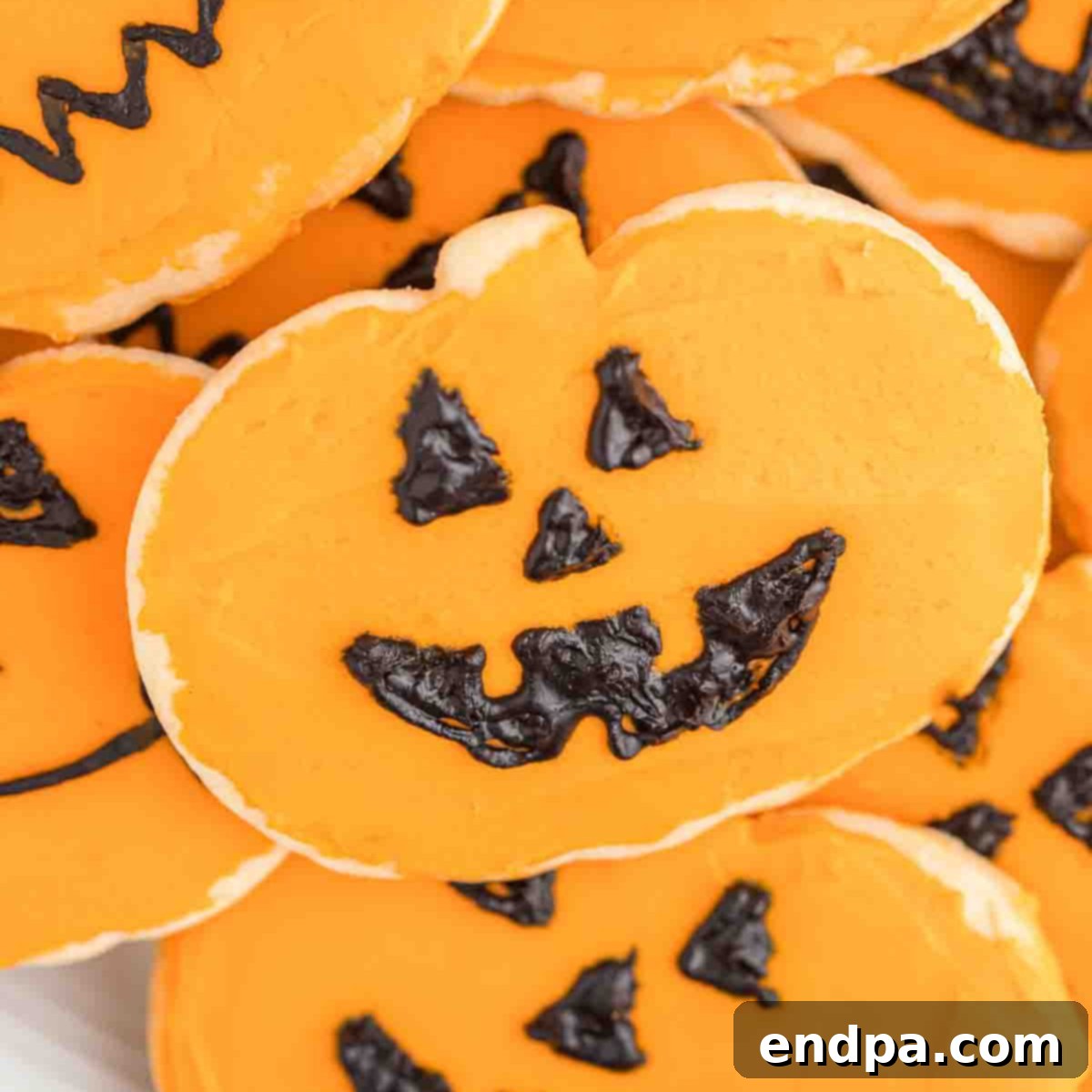 Frightfully Delicious Halloween Cookies 15 Halloween pumpkin cookies decorated with black icing faces.