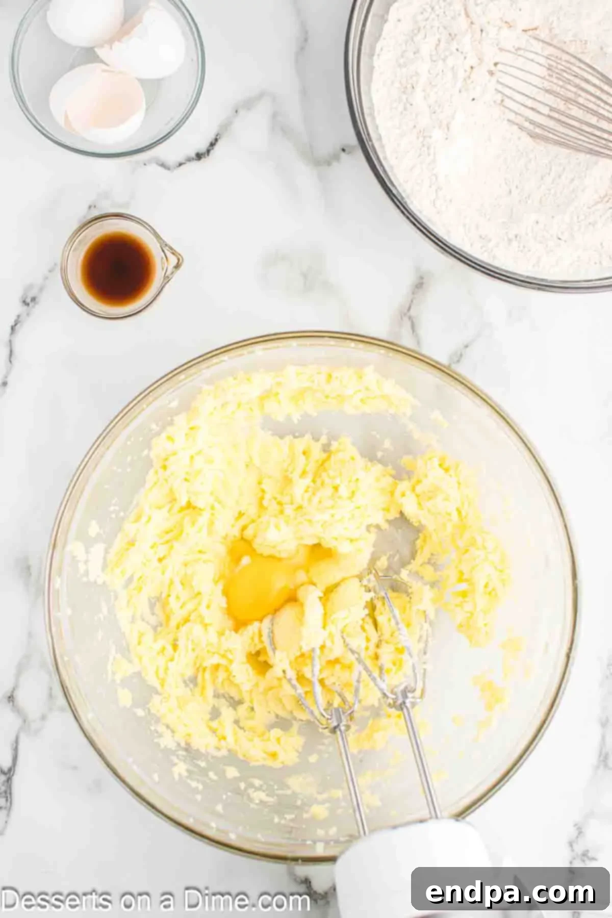Frightfully Delicious Halloween Cookies 5 Creamed butter and sugar with eggs and vanilla extract in a mixing bowl.