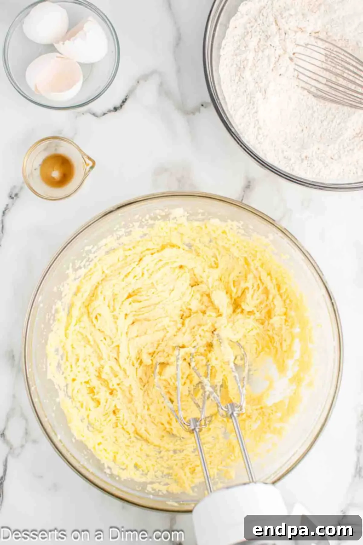 Frightfully Delicious Halloween Cookies 6 Dry ingredients being gradually added to the butter mixture to form cookie dough.