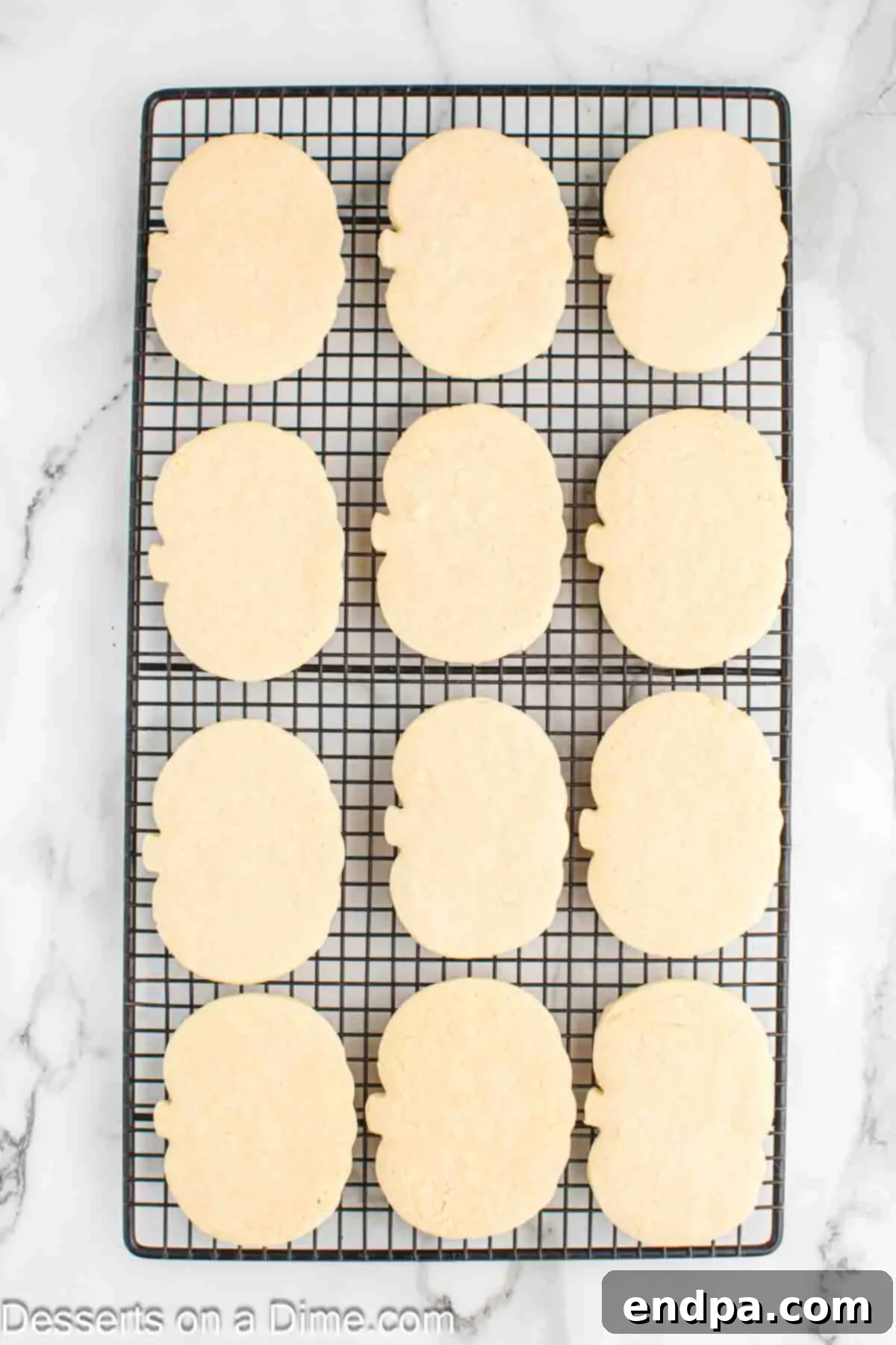 Frightfully Delicious Halloween Cookies 9 Baked sugar cookies cooling on a wire rack.