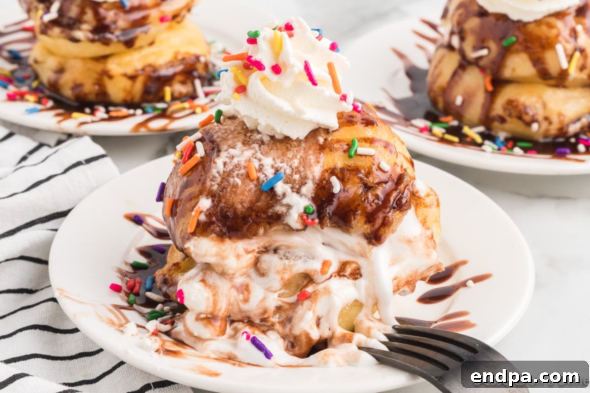 Deep fried marshmallows on plate topped with whipped cream and sprinkles.