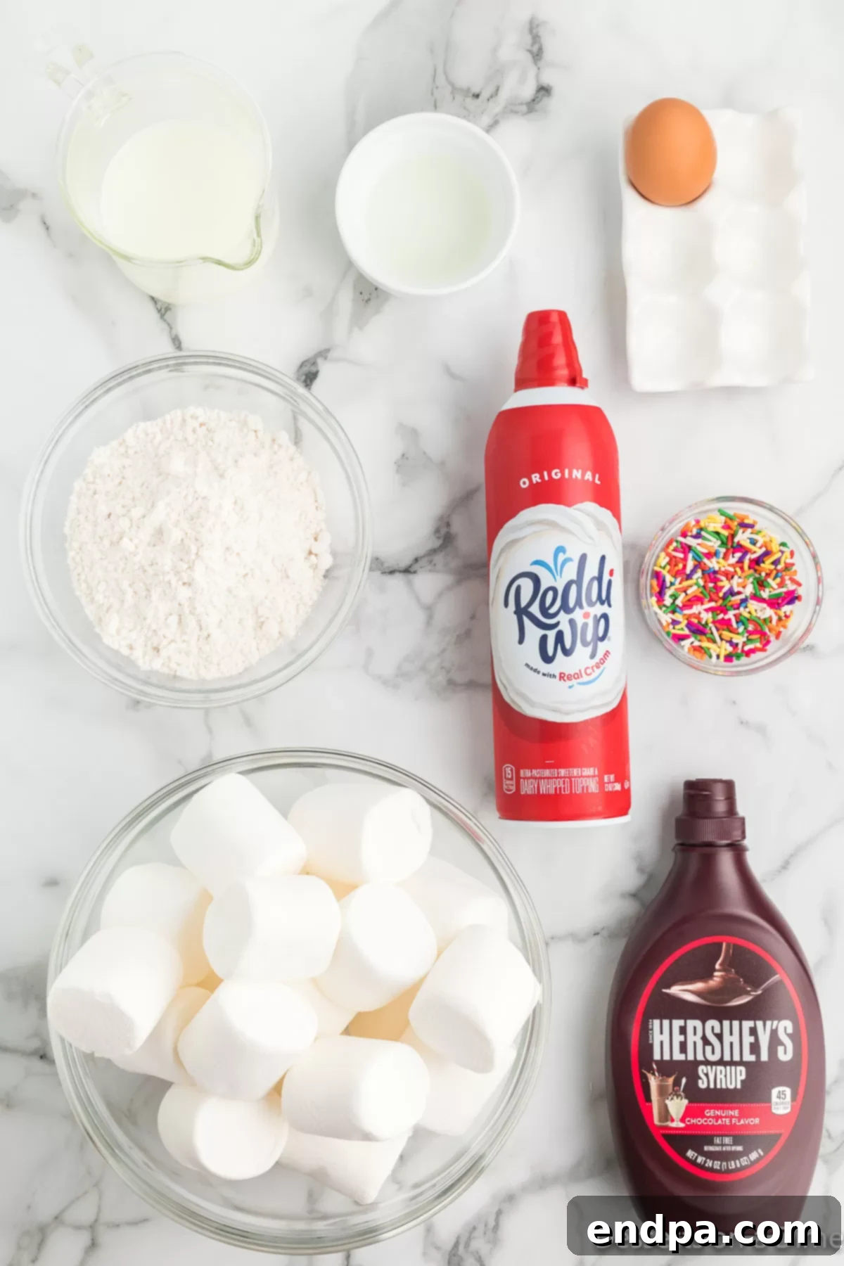 Ingredients for Deep Fried Marshmallows - jumbo marshmallows, pancake mix, milk, sprinkles, chocolate sauce. 