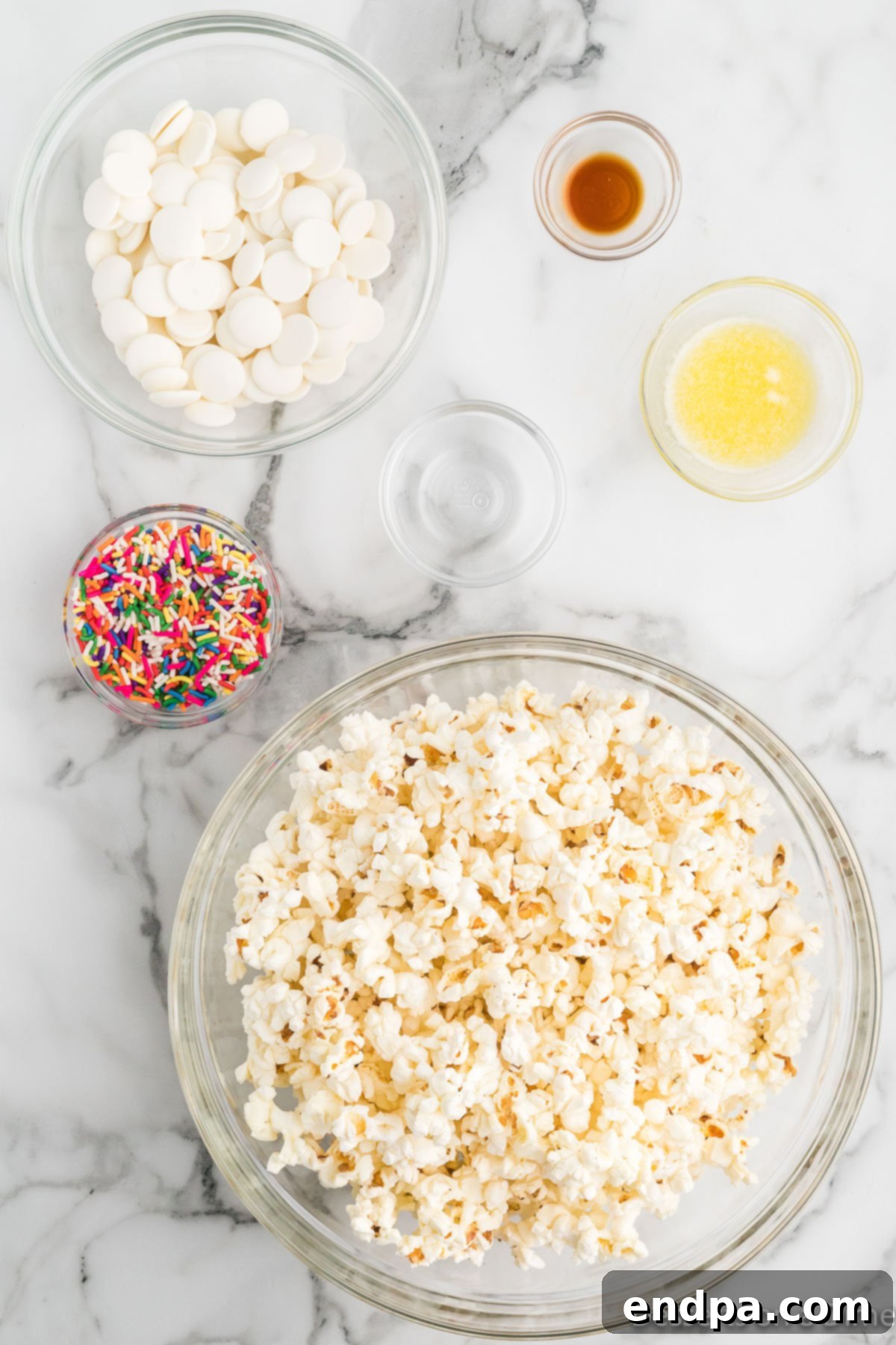 Bakery Sweet Popcorn 3 Ingredients for Sugar cookie popcorn - popcorn, vanilla, sprinkles, candy melts.