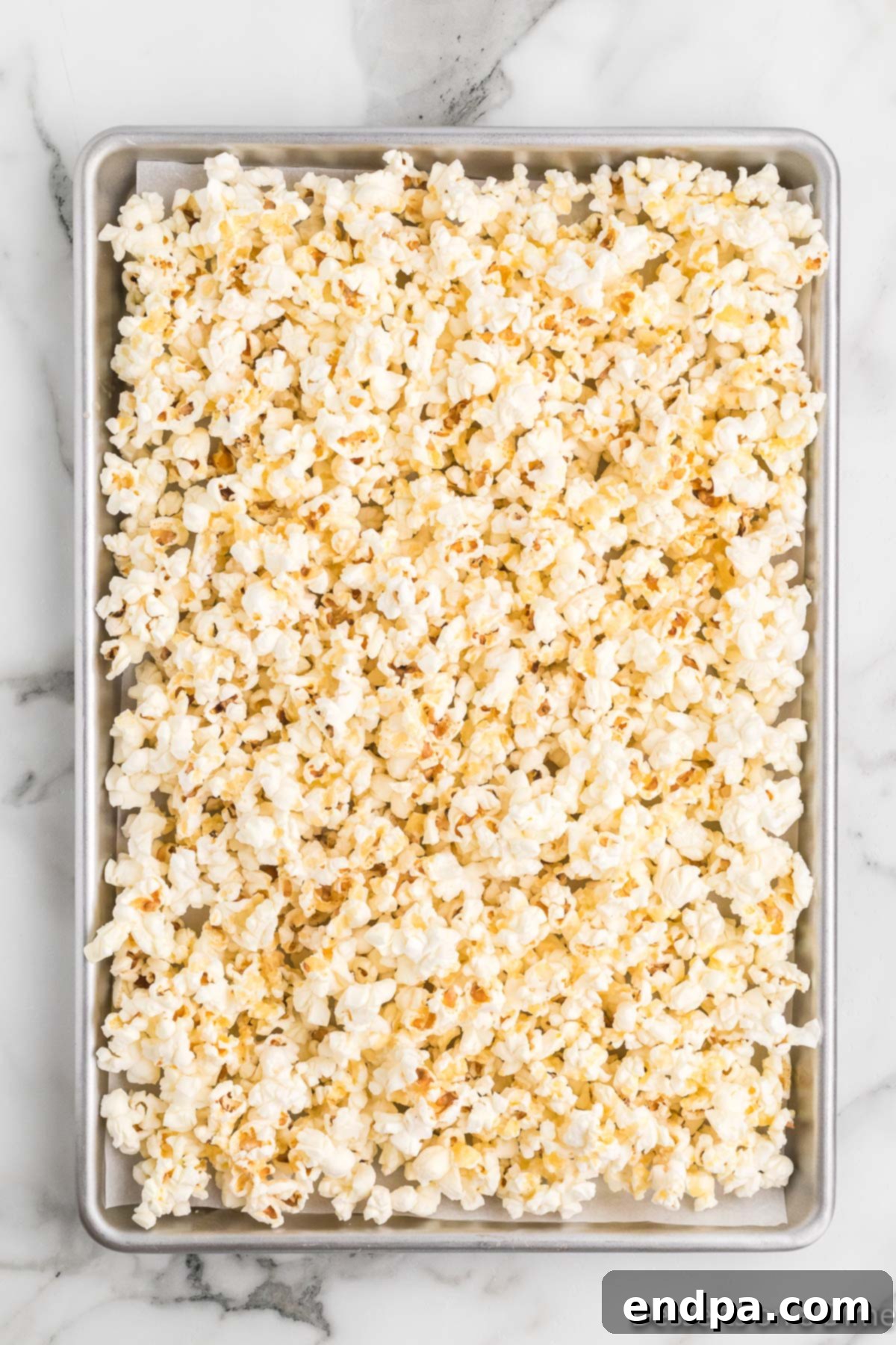 Bakery Sweet Popcorn 4 Popcorn spread on baking sheet.