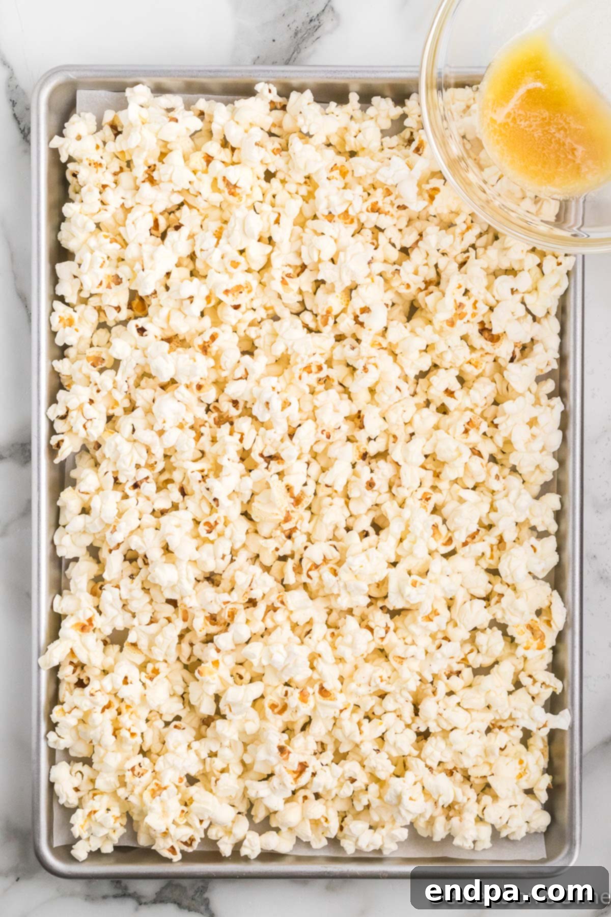 Bakery Sweet Popcorn 6 Butter mixture poured over popcorn.