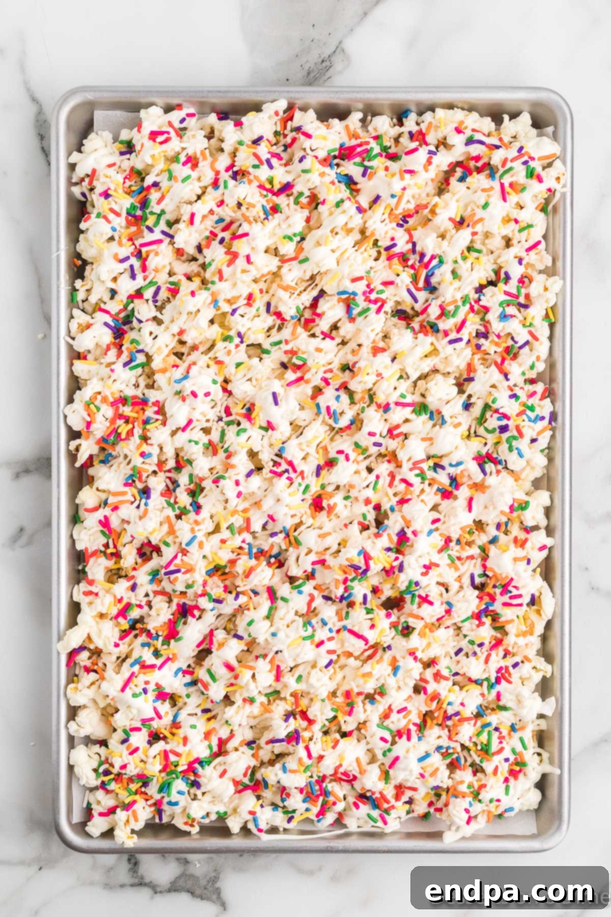 Bakery Sweet Popcorn 9 Sprinkles on top of popcorn.