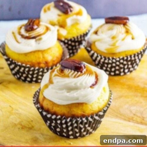 Decadent Maple Bacon Bourbon Pecan Cupcakes with creamy frosting and bacon bits.